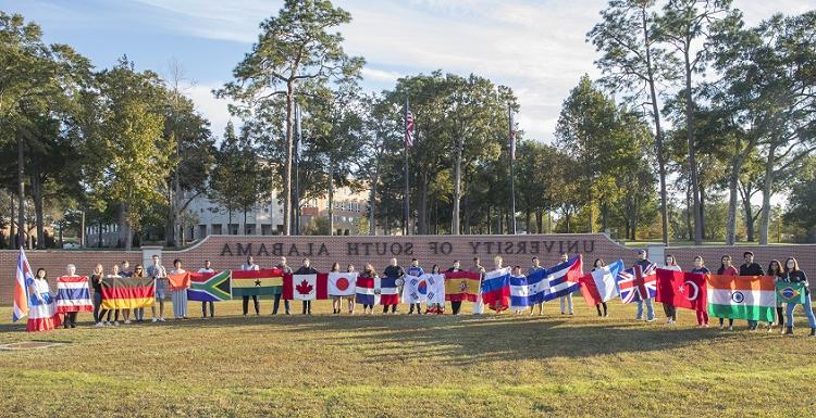学生 representing their home countries gather for a group photo as part of International Education Week. 